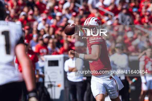 Wisconsin Badgers quarterback Braedyn Locke #18 throws a pass while on the run against the Purdue Boilermakers at Camp Randall Stadium in Ma...