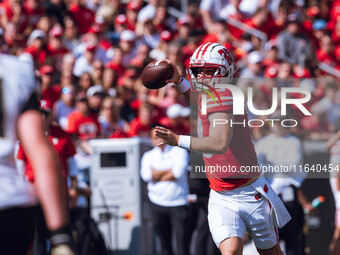 Wisconsin Badgers quarterback Braedyn Locke #18 throws a pass while on the run against the Purdue Boilermakers at Camp Randall Stadium in Ma...