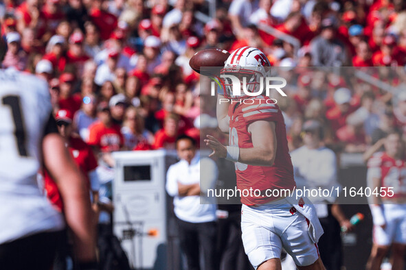 Wisconsin Badgers quarterback Braedyn Locke #18 throws a pass while on the run against the Purdue Boilermakers at Camp Randall Stadium in Ma...