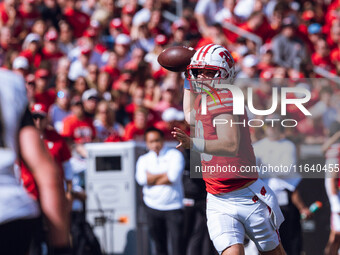 Wisconsin Badgers quarterback Braedyn Locke #18 throws a pass while on the run against the Purdue Boilermakers at Camp Randall Stadium in Ma...