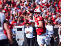 Wisconsin Badgers quarterback Braedyn Locke #18 throws a pass while on the run against the Purdue Boilermakers at Camp Randall Stadium in Ma...