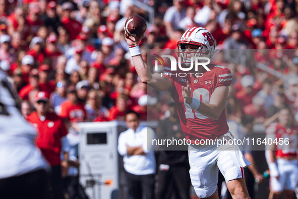 Wisconsin Badgers quarterback Braedyn Locke #18 throws a pass while on the run against the Purdue Boilermakers at Camp Randall Stadium in Ma...