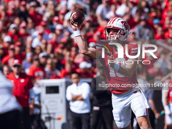 Wisconsin Badgers quarterback Braedyn Locke #18 throws a pass while on the run against the Purdue Boilermakers at Camp Randall Stadium in Ma...