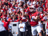 Wisconsin Badgers quarterback Braedyn Locke #18 throws a pass while on the run against the Purdue Boilermakers at Camp Randall Stadium in Ma...