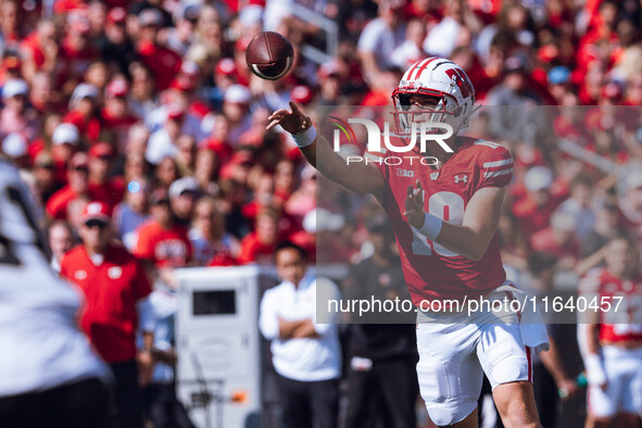 Wisconsin Badgers quarterback Braedyn Locke #18 throws a pass while on the run against the Purdue Boilermakers at Camp Randall Stadium in Ma...