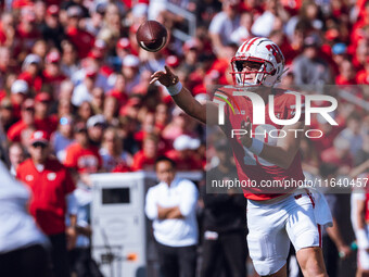 Wisconsin Badgers quarterback Braedyn Locke #18 throws a pass while on the run against the Purdue Boilermakers at Camp Randall Stadium in Ma...