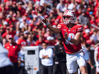 Wisconsin Badgers quarterback Braedyn Locke #18 throws a pass while on the run against the Purdue Boilermakers at Camp Randall Stadium in Ma...