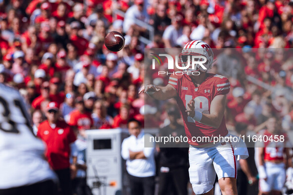 Wisconsin Badgers quarterback Braedyn Locke #18 throws a pass while on the run against the Purdue Boilermakers at Camp Randall Stadium in Ma...