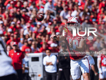 Wisconsin Badgers quarterback Braedyn Locke #18 throws a pass while on the run against the Purdue Boilermakers at Camp Randall Stadium in Ma...