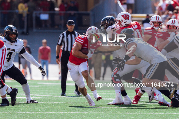 Wisconsin Badgers running back Cade Yacamelli #25 gives a stiff arm against the Purdue Boilermakers at Camp Randall Stadium in Madison, Wisc...