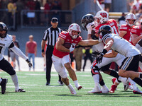 Wisconsin Badgers running back Cade Yacamelli #25 gives a stiff arm against the Purdue Boilermakers at Camp Randall Stadium in Madison, Wisc...