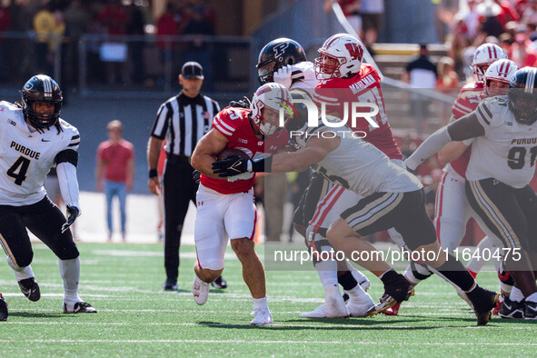 Wisconsin Badgers running back Cade Yacamelli #25 gives a stiff arm against the Purdue Boilermakers at Camp Randall Stadium in Madison, Wisc...