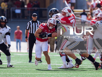 Wisconsin Badgers running back Cade Yacamelli #25 gives a stiff arm against the Purdue Boilermakers at Camp Randall Stadium in Madison, Wisc...