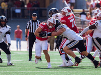 Wisconsin Badgers running back Cade Yacamelli #25 gives a stiff arm against the Purdue Boilermakers at Camp Randall Stadium in Madison, Wisc...