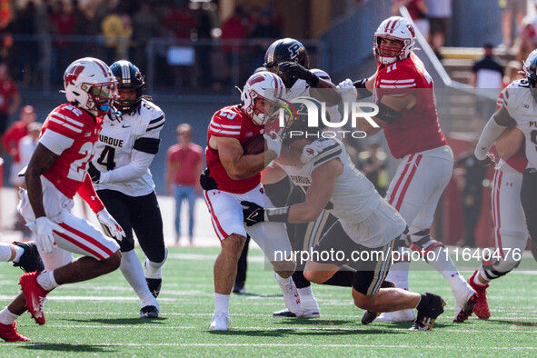 Wisconsin Badgers running back Cade Yacamelli #25 gives a stiff arm against the Purdue Boilermakers at Camp Randall Stadium in Madison, Wisc...