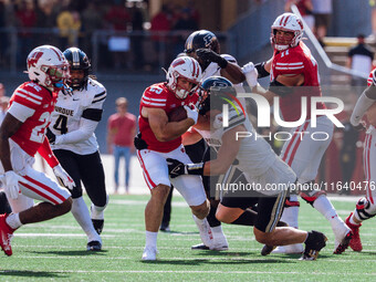 Wisconsin Badgers running back Cade Yacamelli #25 gives a stiff arm against the Purdue Boilermakers at Camp Randall Stadium in Madison, Wisc...