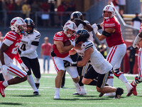 Wisconsin Badgers running back Cade Yacamelli #25 gives a stiff arm against the Purdue Boilermakers at Camp Randall Stadium in Madison, Wisc...