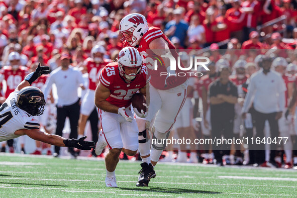 Wisconsin Badgers running back Cade Yacamelli #25 runs in a touchdown against the Purdue Boilermakers at Camp Randall Stadium in Madison, Wi...