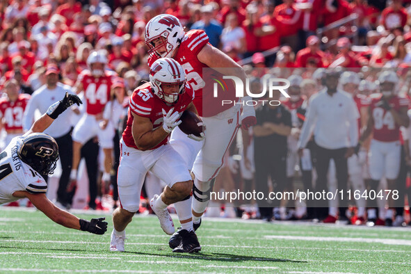 Wisconsin Badgers running back Cade Yacamelli #25 runs in a touchdown against the Purdue Boilermakers at Camp Randall Stadium in Madison, Wi...