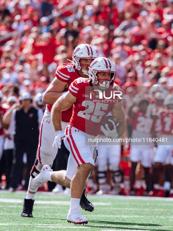 Wisconsin Badgers running back Cade Yacamelli #25 runs in a touchdown against the Purdue Boilermakers at Camp Randall Stadium in Madison, Wi...