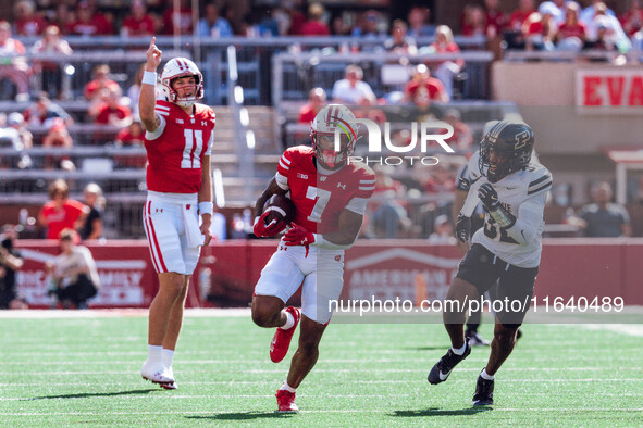 Wisconsin Badgers running back Dilin Jones #7 runs the ball against the Purdue Boilermakers while Wisconsin Badgers quarterback Mabrey Metta...