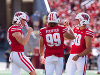 Wisconsin Badgers kicker Nathanial Vakos #90 celebrates with Cayson Pfeiffer #99 and Gavin Meyers #28 against the Purdue Boilermakers at Cam...