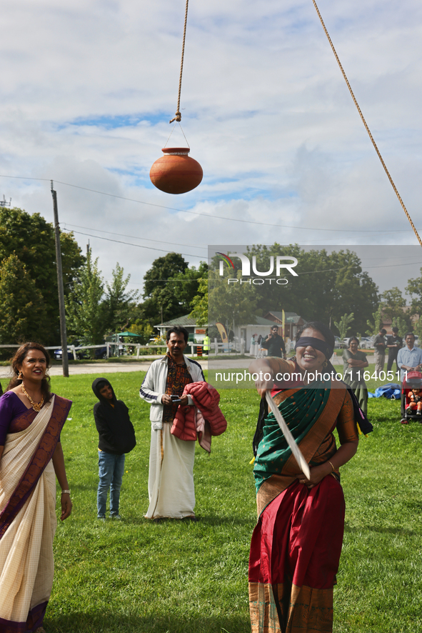 A woman plays the uriyadi game (pot breaking game) during the Onam Festival in Woodbridge, Ontario, Canada, on September 07, 2024. Onam is a...