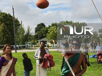 A woman plays the uriyadi game (pot breaking game) during the Onam Festival in Woodbridge, Ontario, Canada, on September 07, 2024. Onam is a...