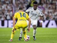 Vinicius Junior of Real Madrid CF (right) is in action with the ball against Santi Comesana of Villarreal CF (left) during the La Liga EA Sp...