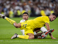 Jude Bellingham of Real Madrid CF (L) is in action against Santi Comesana of Villarreal CF (R) during the La Liga EA Sports 2024/25 football...