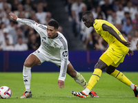 Jude Bellingham of Real Madrid CF (L) is in action with the ball against Pape Gueye of Villarreal CF (R) during the La Liga EA Sports 2024/2...