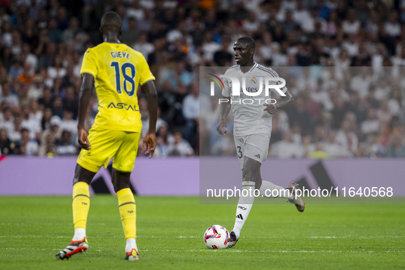 Ferland Mendy of Real Madrid CF (R) is in action with the ball against Pape Gueye of Villarreal CF (L) during the La Liga EA Sports 2024/25...