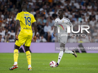 Ferland Mendy of Real Madrid CF (R) is in action with the ball against Pape Gueye of Villarreal CF (L) during the La Liga EA Sports 2024/25...