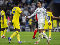 Jude Bellingham of Real Madrid CF (R) cheers Logan Costa of Villarreal CF (L) at the end of the La Liga EA Sports 2024/25 football match bet...