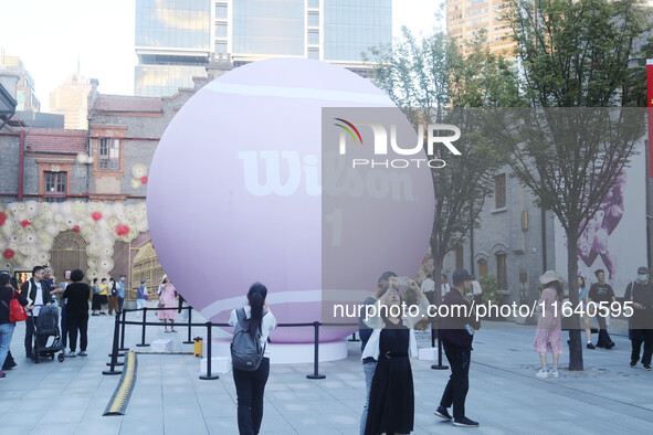 A giant pink tennis ball installation by American sports brand Wilson is seen in Shanghai, China, on October 4, 2024. 