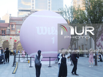 A giant pink tennis ball installation by American sports brand Wilson is seen in Shanghai, China, on October 4, 2024. (