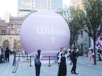 A giant pink tennis ball installation by American sports brand Wilson is seen in Shanghai, China, on October 4, 2024. (