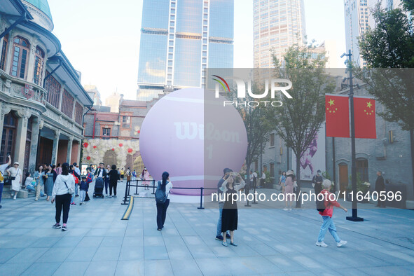 A giant pink tennis ball installation by American sports brand Wilson is seen in Shanghai, China, on October 4, 2024. 