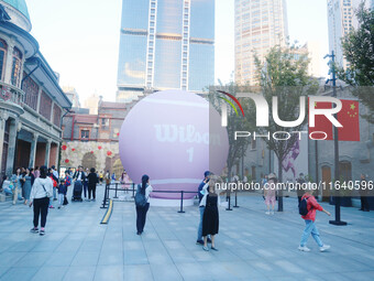 A giant pink tennis ball installation by American sports brand Wilson is seen in Shanghai, China, on October 4, 2024. (