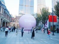 A giant pink tennis ball installation by American sports brand Wilson is seen in Shanghai, China, on October 4, 2024. (