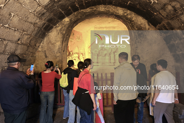 Tourists visit the Xiangtang Mountain Grottoes in Handan, China, on October 5, 2024. 