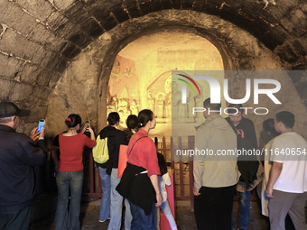 Tourists visit the Xiangtang Mountain Grottoes in Handan, China, on October 5, 2024. (