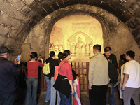 Tourists visit the Xiangtang Mountain Grottoes in Handan, China, on October 5, 2024. (