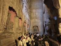 Tourists visit the Xiangtang Mountain Grottoes in Handan, China, on October 5, 2024. (