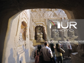 Tourists visit the Xiangtang Mountain Grottoes in Handan, China, on October 5, 2024. (