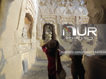 Tourists visit the Xiangtang Mountain Grottoes in Handan, China, on October 5, 2024. (