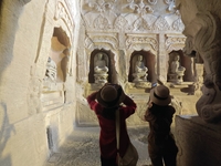 Tourists visit the Xiangtang Mountain Grottoes in Handan, China, on October 5, 2024. (