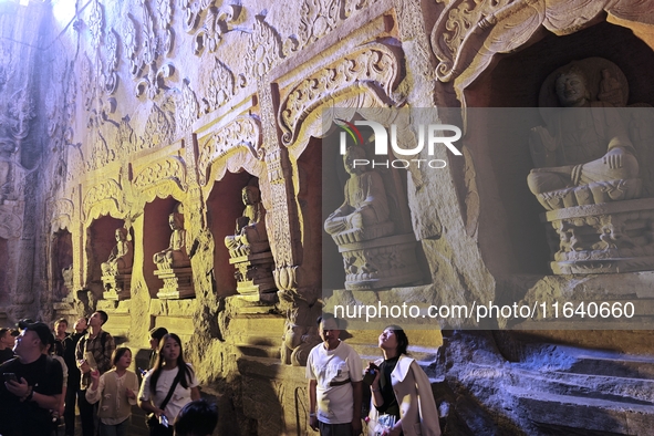 Tourists visit the Xiangtang Mountain Grottoes in Handan, China, on October 5, 2024. 