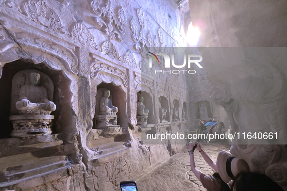 Tourists visit the Xiangtang Mountain Grottoes in Handan, China, on October 5, 2024. 