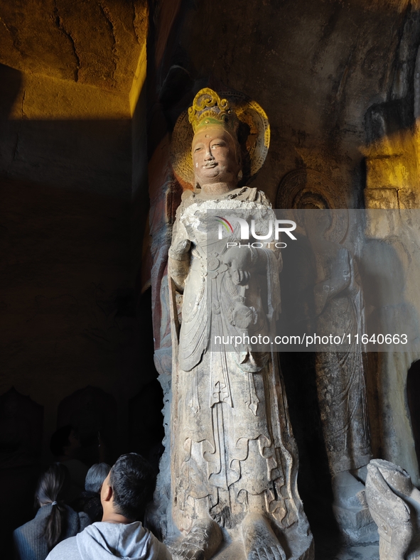 Tourists visit the Xiangtang Mountain Grottoes in Handan, China, on October 5, 2024. 